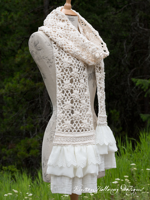 A beautiful lacy summer scarf with flowers and ruffles sewed to the ends.
