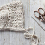Crochet a classic T-shaped baby bonnet with this free pattern.