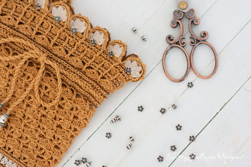 Close-up of lace boot cuffs with metal flower beads.