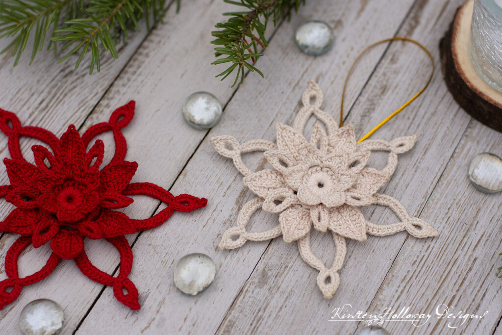 Close-up detail of a red and a white crocheted poinsettia flower ornament