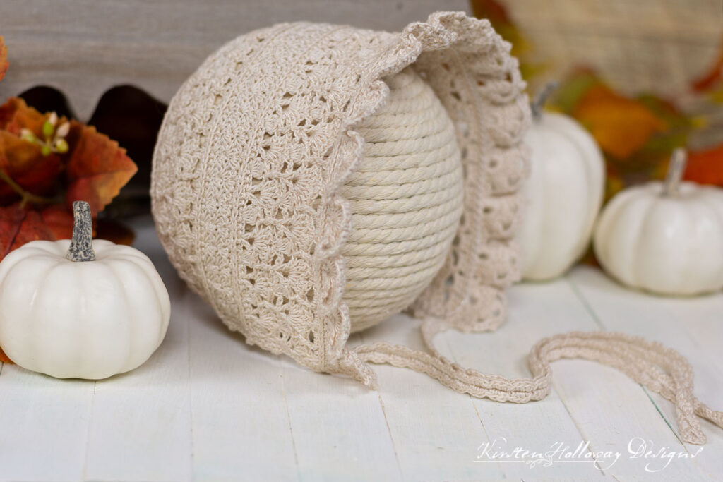 Plain, Natural (off-white) colored crochet lace baby bonnet. 